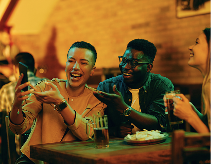 Friends laughing at a bar in NoDa Charlotte, NC